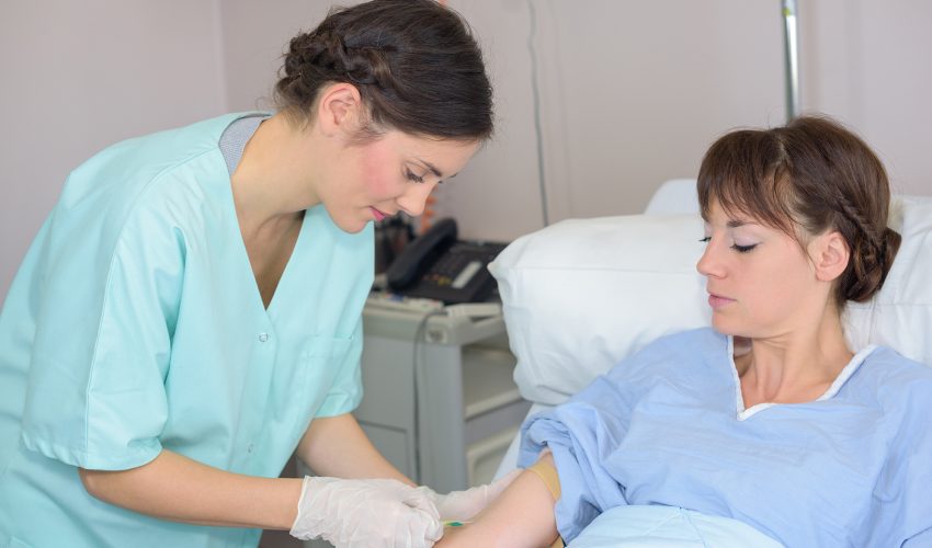 Nurse holding patient's arm