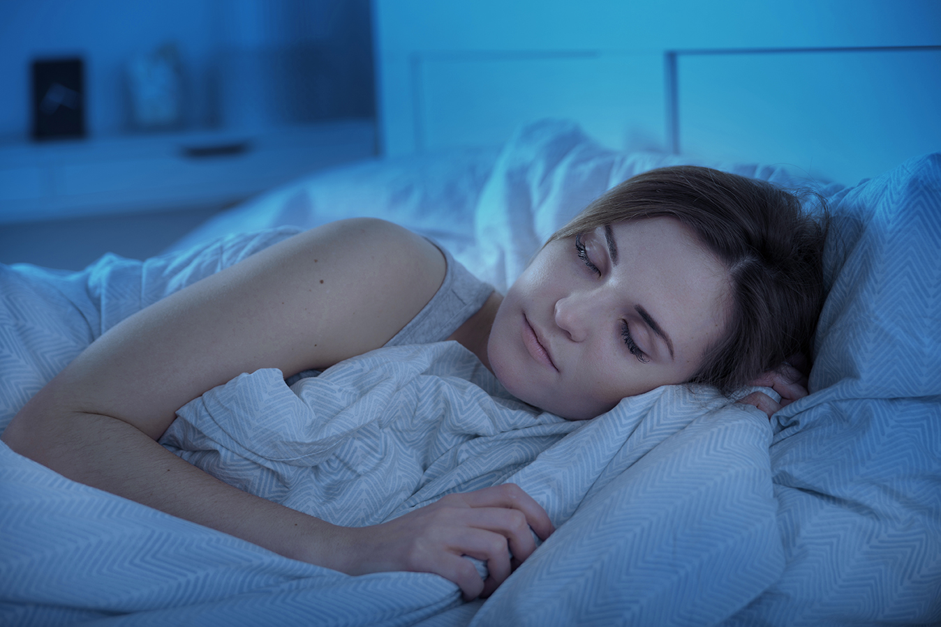 Girl peacefully sleeping in bed at night Nurse Advisor Magazine